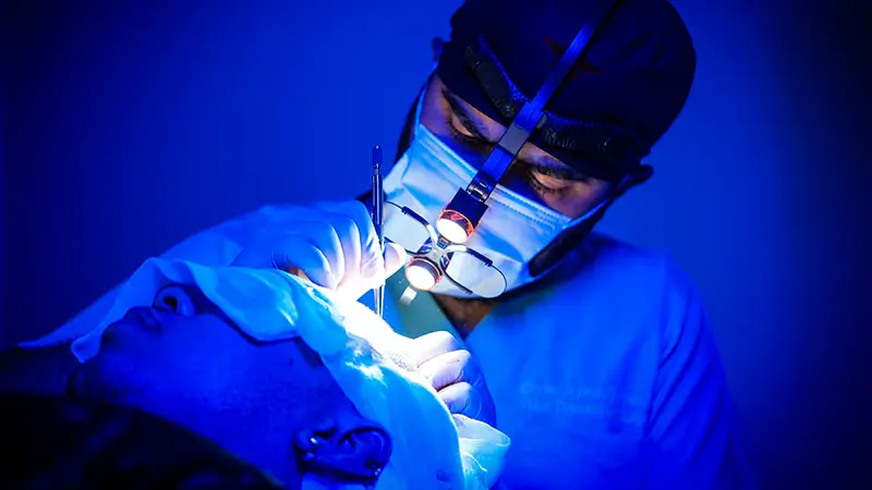 Dr. Aykut performing hair transplant surgery