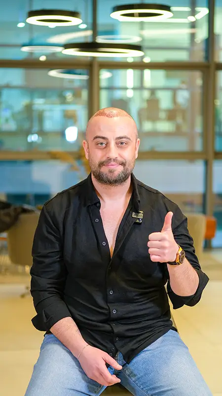 Happy patient after hair transplant procedure giving thumbs up