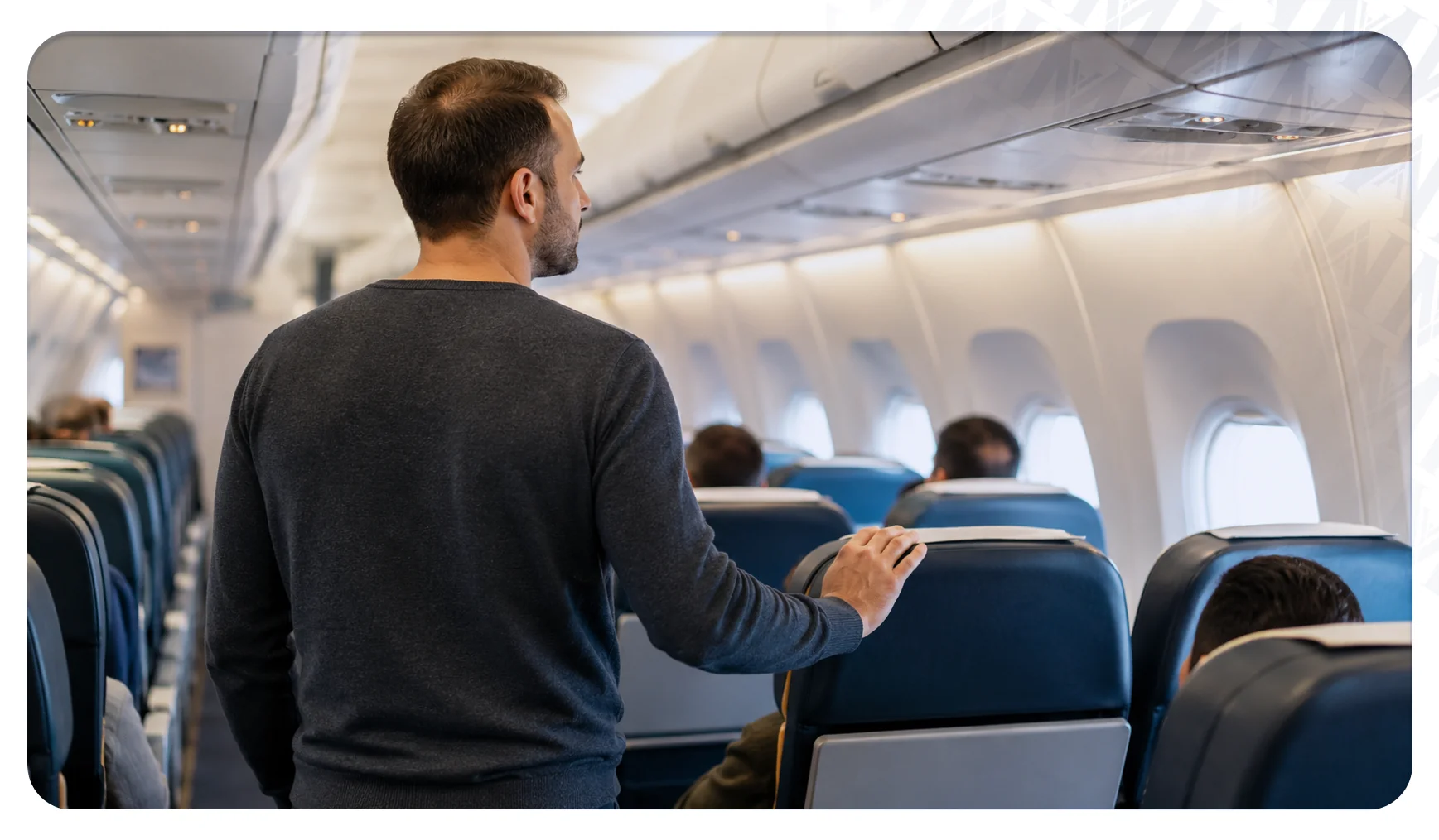 Hair transplant patient walking gently along an aircraft aisle to reduce immobility on a long-haul flight.